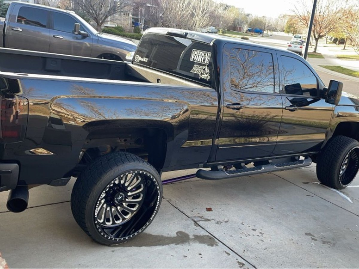 Lifted black pickup with American Force wheels after exterior detailing in Thornton, Colorado