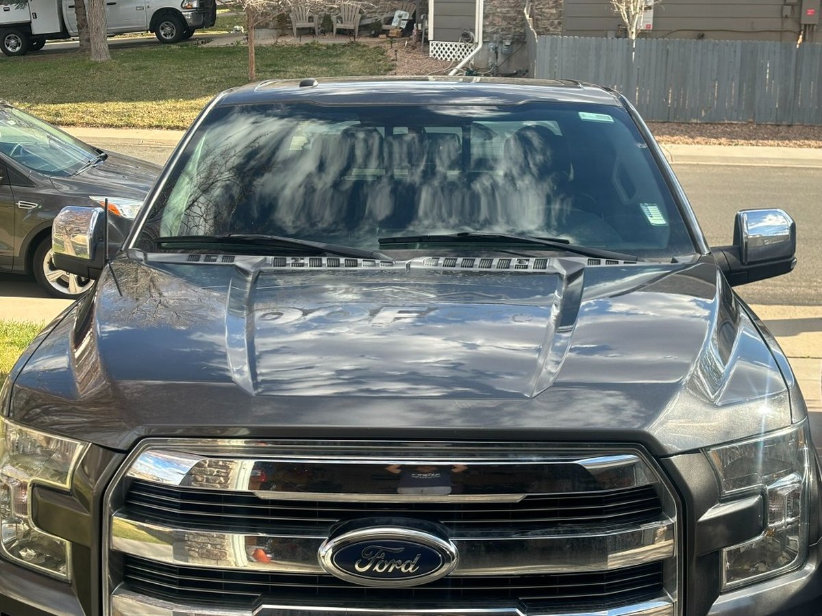 Ford F-150 hood with clear coat failure before paint correction