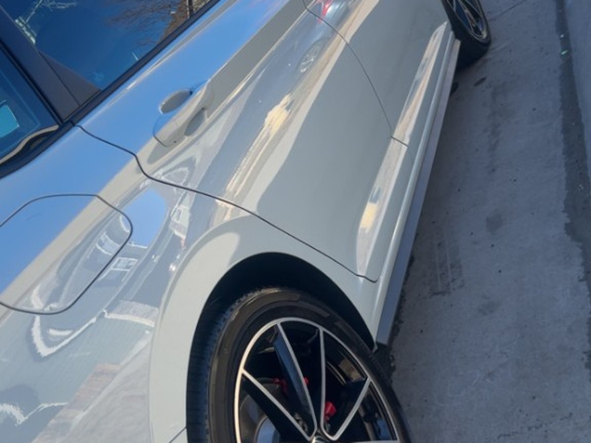Glossy Volkswagen side profile and wheel after paint polish and exterior detail