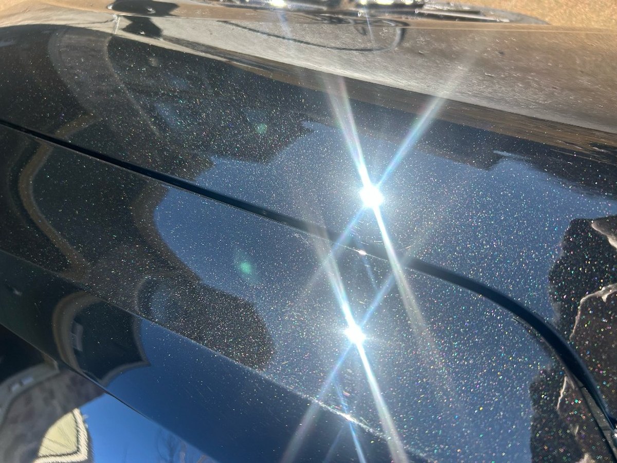 Close-up of mirror-finish metallic paint after polishing by Dean Auto